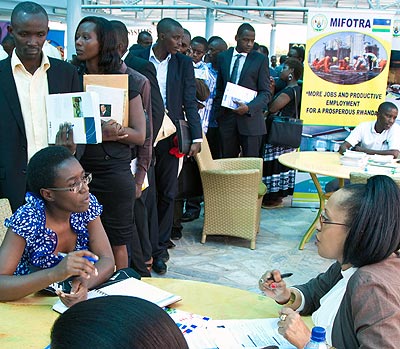 Customer service personnel talk to potential employees during a job fair in Kigali early this year.   The New Times/ File. 