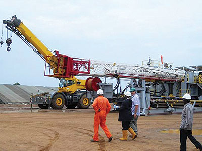 Oil workers at Kigogole-5 oil well in Buliisa District. Countries like Iran and China have been pointed  out as interested in oil investment. Net photo