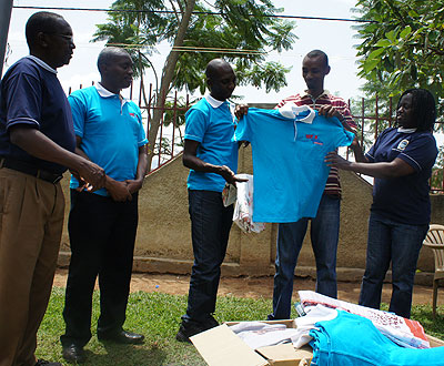 Ruzindana receiving some clothes for the children donated by Mount Kenya university lecturers. The New Times/ E. Kabera.