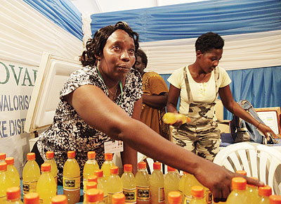 A juice maker displays her products at a trade fair. EADB is going to fund such business women