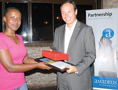 Ingabire receives the return air ticket she won from Torres. The New Times / Ambroise Agaba