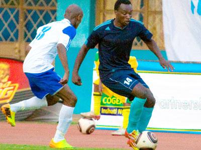 Police's striker Kipson Atuheire attempts to strike past Rayon Sports' Djamal Mwiseneza in yesterday's match at Amahoro stadium. Sunday Sport/T. Kisambira