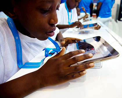 Children browse the Internet at the summit in Kigali on Tuesday. The New Times/T. Kisambira