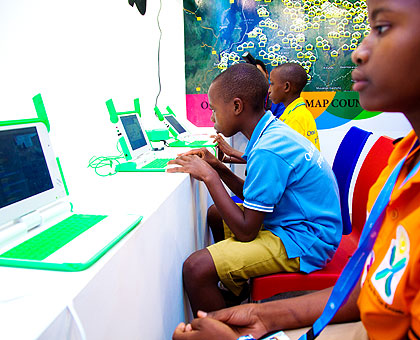 Kids use laptops at an exhibition during the ongoing Transform Africa Summit in Kigali. The New Times/T. Kisambira