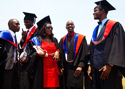 Graduates of former KIST share a light moment after a graduation ceremony. The New Times / File.