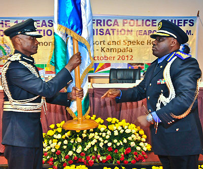 Rwanda Inspector General of Police IGP Emmanuel K. Gasana (R) hands over the Eastern Africa Police Chiefs Cooperation Organisation (EAPCCO) flag to his Ugandan counterpart, Kale Kayihura, who took over from the former as the regional bodyu2019s head last year. The New Times/File.