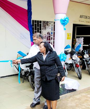  Pramod Yadav (L), the regional manager of VK Auto, and Mwijukye cut a ribbon during the VK  motorcycle distribution in the country. The New Times/Timothy Kisambira