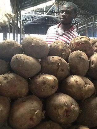 An Irish potato seller in Kimironko Market waits for customers. Prices have reduced by almost half. The New Times / Seraphine Habimana