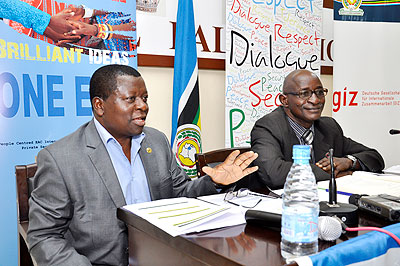 Richard Owora (L), the head of the corporate communication department at the EAC Secretariat, briefs the media on the local justice system as Amb. Rigi looks on.    The New Times/ Courtesy.