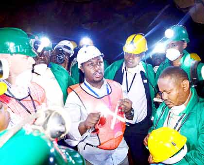 State Minister for Mining Evode Imena (C) briefs visitors on a tour of Rutongo Mines in Rulindo District yesterday.   The New Times/ John Mbanda.