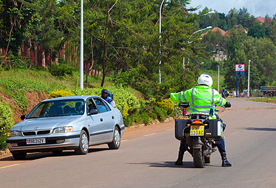 A traffic police officer pulls over a car in Kicukiro, Kigali. The New Times / T. Kisambira. 