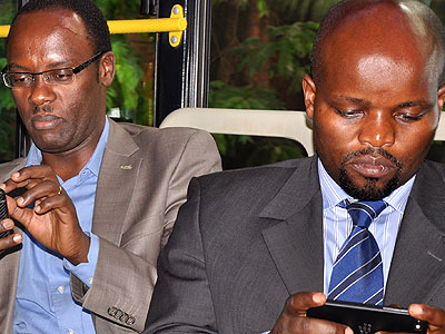 Nsengimana (R) and the City of Kigali Mayor Fidu00e8le Ndayisaba busy on the internet at the launch of Smart Kigali which provides free wireless internet in September this year. The New Times/File