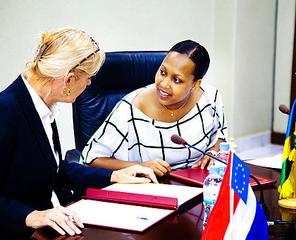 Leaon Cuelenaere (L), the Dutch Ambassador to Rwanda, chats with Kampeta Sayinzoga, before the signing ceremony. The New Times/ Timothy Kisambira.