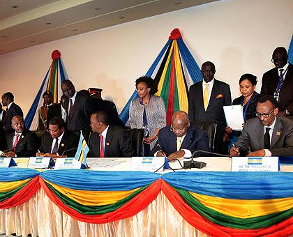 President Kagame with his counterparts: Yoweri Museveni, Uhuru Kenyatta, Jakaya Kikwete and Jean-Pierre Nkurunziza sign the East African Community Monetary Union protocol scheduled to be implemented in July 2014. Sunday Times/Village Urugwiro