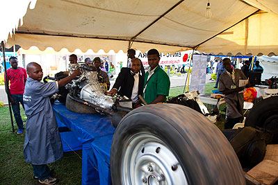 Jean Damascene Ahabaguhirwe from VCT expert motors centre showing how the car engine system works at the ongoing  TVET expo. The New Times / T. Kisambira. 