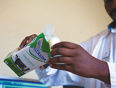 A standards body official measures milk as he prepares to test it. The body has increased drives to educate the public, especially producers and service providers, about key standards to boost product and service quality. The New Times / Ivan Ngoboka