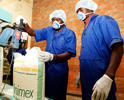 Workers package products at a grain milling factory. 