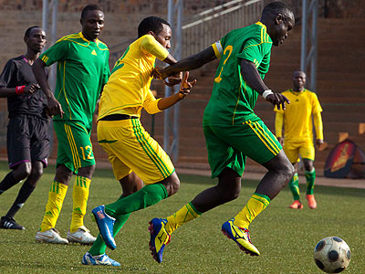 Marines skipper Bonaventure Hategekimana shields the ball past AS Kigali striker Justin Mico (yellow) in a past league match. AS Kigali leads the standings. Times Sports/File