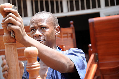 A carpenter puts final touches to his work in Gakiriro. The New Times / John Mbanda.