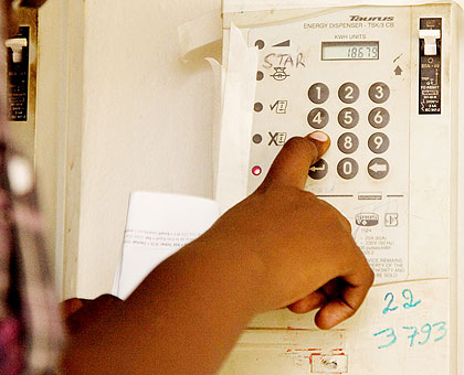 A person loads prepaid power voucher on the meter. MPs want load shedding addressed. The New Times/ File.