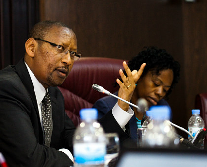 National Bank of Rwanda governor John Rwangombwa (L), flanked by his deputy Monique Nsanzabaganwa, address the media in Kigali yesterday. Rwangombwa said inflation is projected to drop next year.The New Times/ Timothy Kisambira.