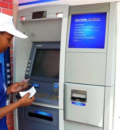 A client using a BK ATM in Kigali. The New Times /File