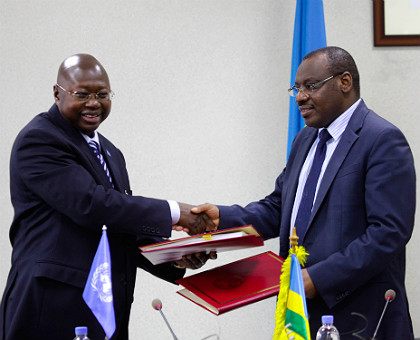 Finance and Economic Planning minister Claver Gatete (R) exchanges agreement files with UN Resident Coordinator and UNDP Country Representative Lamin M. Manneh in Kigali yesterday. The government signed a Rwf19b deal to support six programmes under EDPRS2.  The New Times/ T. Kisambira.