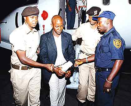 One of the convicts being handed over to Rwanda Correctional Services officers at Kigali International Airport in 2009. The New Times/ File.