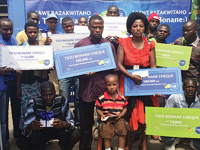 Umutoniwase (foreground, right) and other winners pose with their dummy cheques and phones. The New Times/Ben Gasore