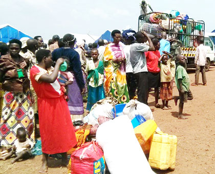 Some of the citizens in Rukara Camp in Kayonza District prepare to board trucks ahead of their resettlement yesterday. A total of 14,533 persons were expelled from Tanzania in August last year. Of the evictees, 8,361 have already been reunited with their families in various parts of the country, and it is the 5,000-plus citizens who were still left in camps who are being resettled at districts of their choice. . The New Times/ Courtesy.