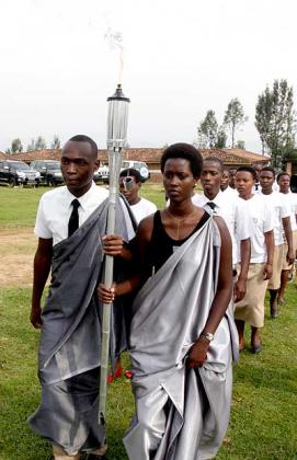 Twenty-year olds receive the Kwibuka (Remembrance) Flame as it made its way to Nyange Secondary School in Ngororero District on Friday on its first leg of a three-month nationwide tour ahead of the 20th anniversary of the 1994 Genocide against the Tutsi. The New Times/Timothy Kisambira.