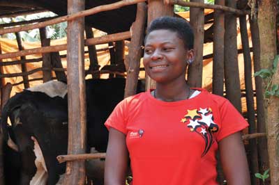 One of the Airtel u2018Birahebujeu2019 promotion winners, Anna Uwamwami, poses with the exotic dairy cow she won last week. The New Times / Peterson Tumwebaze.