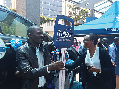 Habyarimana receives a dummy car key for the Rav4 from an Ecobank official on Monday. The New Times/Ben Gasore