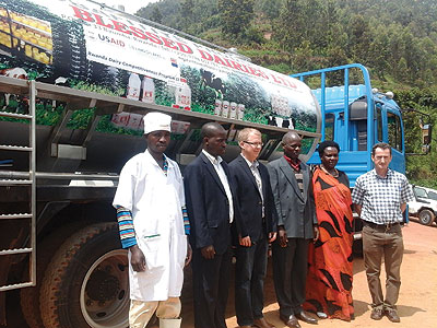 Halverson (centre) and Ou2019Brien (far right) pose for a picture with Blessed Dairy officials after handing over the  truck on Thursday. The New Times / Peterson Tumwebaze