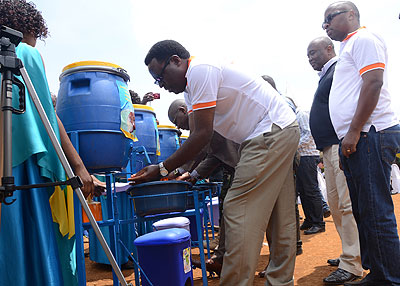 Dr Jean de Dieu Ngirabega leads the hand washing exercise. He encouraged residents of Nkombo to develop a hand washing culture.  The New Times/ T. Kisambira.