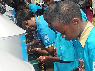 The Minister for Health, Dr Agnes Binagwaho and students wash hands during a hygiene campaign. Sunday Times/File