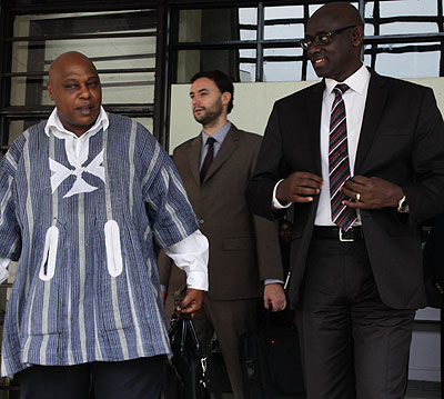 Justice Minister Johnston Busingye (R) chats  with the UN special rapporteur on the rights of freedom of assembly and association, Maina Kiai, yesterday. The New Times/ John Mbanda.