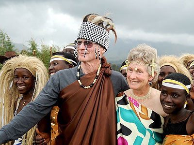 Tourist couple Joe and Mary Ann McDonald with a cultural dance troupe in Musanze in November, 2012. This was on the coupleu2019s 75th visit to the Volcanoes National Park, home to the endangered mountain gorillas  The New Times/John Mbanda