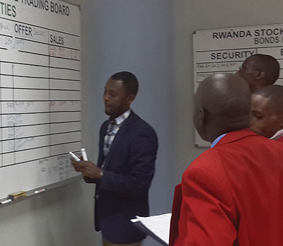 Stock brokers transacting business at the Rwanda Stock Exchange (RSE) yesterday. The New Times / Ben Gasore