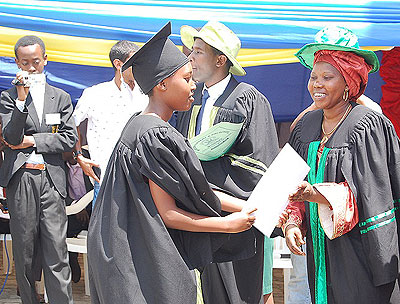 One of the parents congratulates a candidate upon her success. The children vowed to continue being ambassadors of the school.The New Times/ Jean J. Mbonyinshuti.