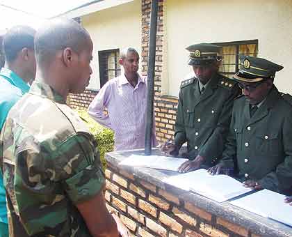 Lt. Mutabazi  and his co-accused brother and uncle before the judges at his uncleu2019s home in Rwamagana yesterday. The New Times/ E. Musoni. 