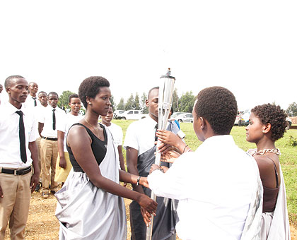 Students of Nyange school in Ngororero receive the Kwibuka Flame on January 10 as the torch embarked on its nationwide lap of honour ahead of the 20th anniversary of the 1994 Genocide against the Tutsi. Nyange school (in the background, right) was on March 18, 1997 attacked by the remnants of the Genocide machinery, with the assailants killing six students after the youngsters refused to separate themselves along ethnic lines. Both the victims and the survivors of the attack are among the heroes  feted today. The New Times/T. Kisambira.