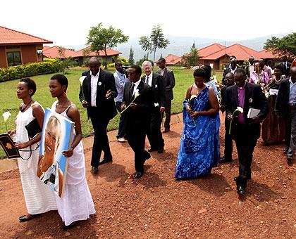 Mourners walk through Agahozo Shalom Village yesterday before laying flowers under a mango tree where Anne Heyman concluded purchase of the land in 2007. John Mbanda