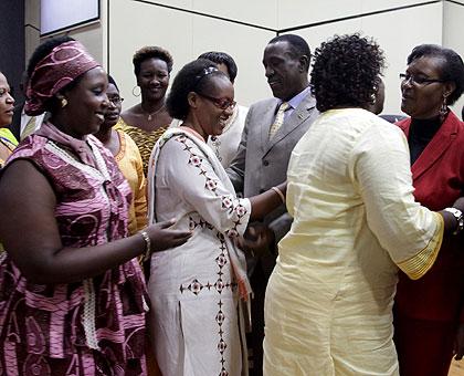 Senate President Jean-Damascu00e8ne Ntawukuliryayo (2R) and Speaker of the lower chamber Donatille Mukabalisa (R) congratulate new members of RPRPD. John Mbanda