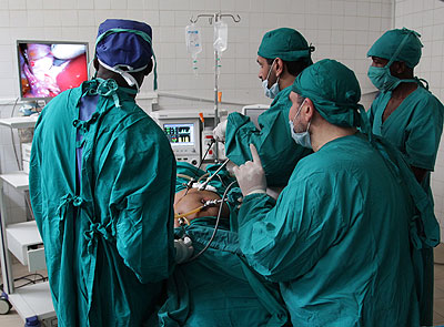 A team of surgeons from Egypt looks at a monitor screen as they carry out an operation on a patient  at CHUK in Kigali on Thursday. John Mbanda. 