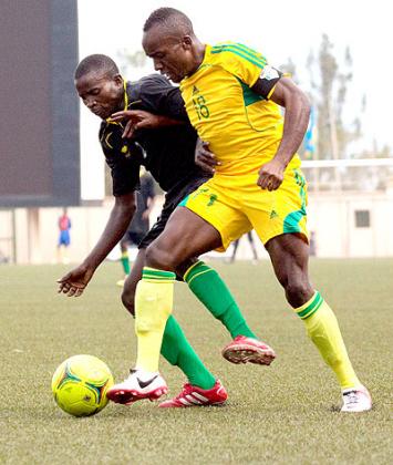 Skipper Jimmy Mbaraga (right) battles for ball possesion against an Academie Tchiteu2019s player during the  first leg in Kigali. He scored the all-important away goal for AS Kigali.....