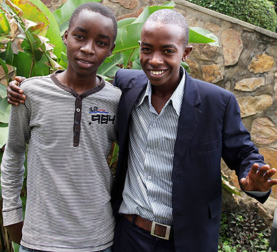 Kwizera (left) and Karuhanga congratulate each other after getting their results. The duo scored 73 aggregates in their respective subject combinations. /John Mbanda 