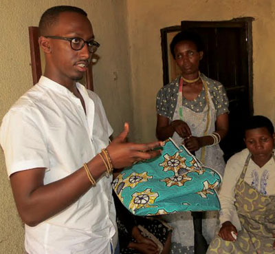 Rugamba explains how they make attire from African fabrics. Below, one of the workers does what she knows best. The New Times / Peterson Tumwebaze