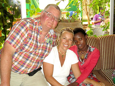 Micheline and Normand pose for a photo with one of the students they sponsor at Kayonza Vocational School. Courtesy