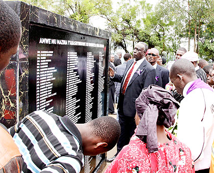 Survivors look at a wall in Rebero in Kigali bearing names of their relatives who perished during the Genocide. (File)